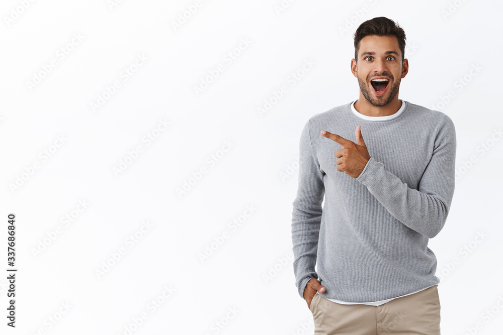 Wall Mural Fascinated happy and excited handsome young male coworker discuss boss new car,