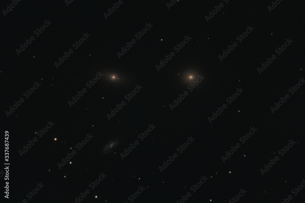 The elliptical galaxy Messier 105, the lenticular galaxy NGC 3384, and the spiral galaxy NGC 3389 in the constellation Leo photographed with a Maksutov telescope from Mannheim in Germany.