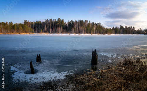 spring Ural landscape with frozen river and forest, Russia, April