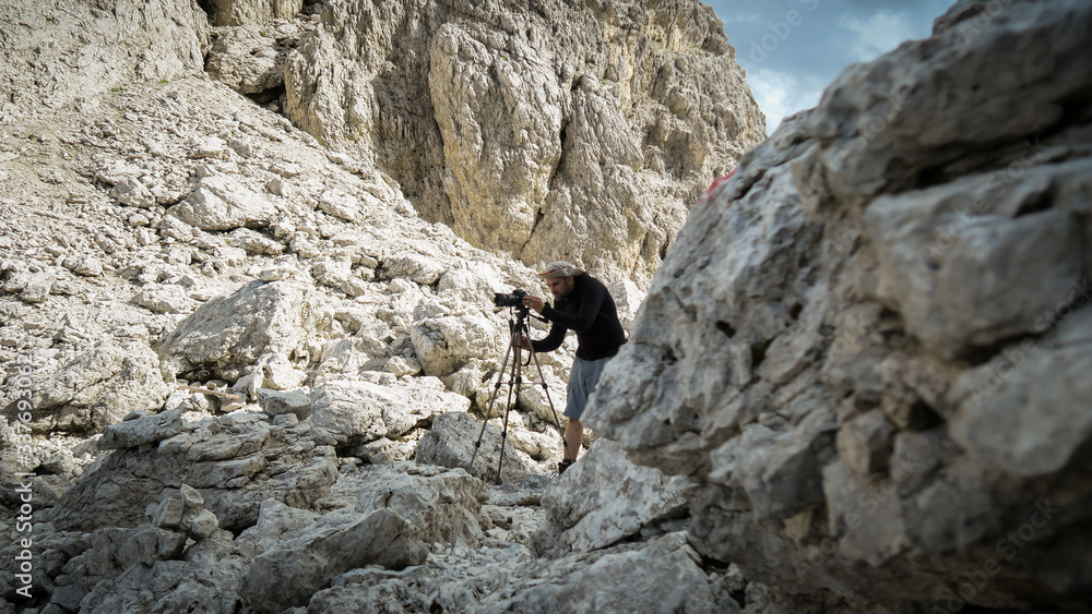 Tourist takes a picture of beautiful views from the mountain trail in the Dolomites