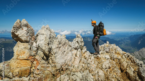 Tourist with equipment on the via ferrata trail in the alps