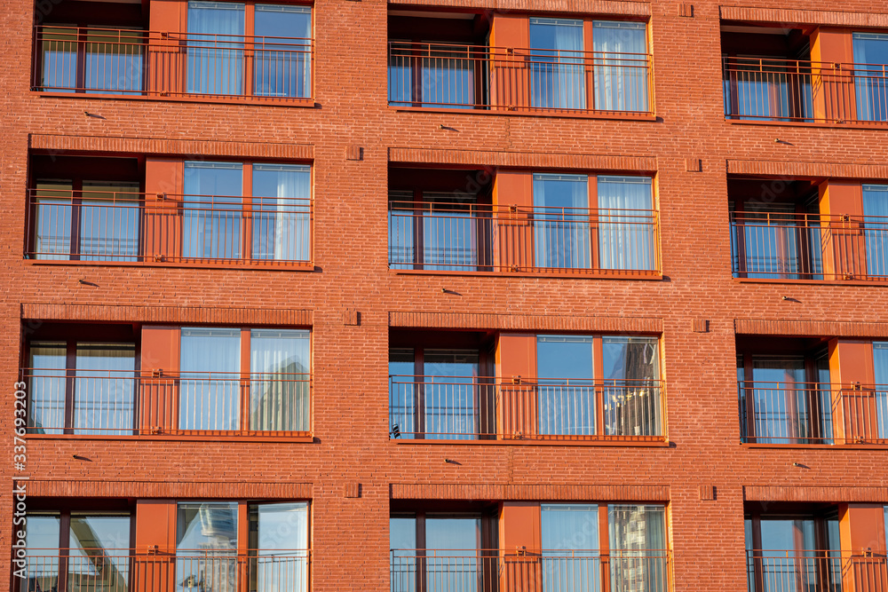 Fototapeta premium Facade of a modern red apartment house seen in Frankfurt, Germany