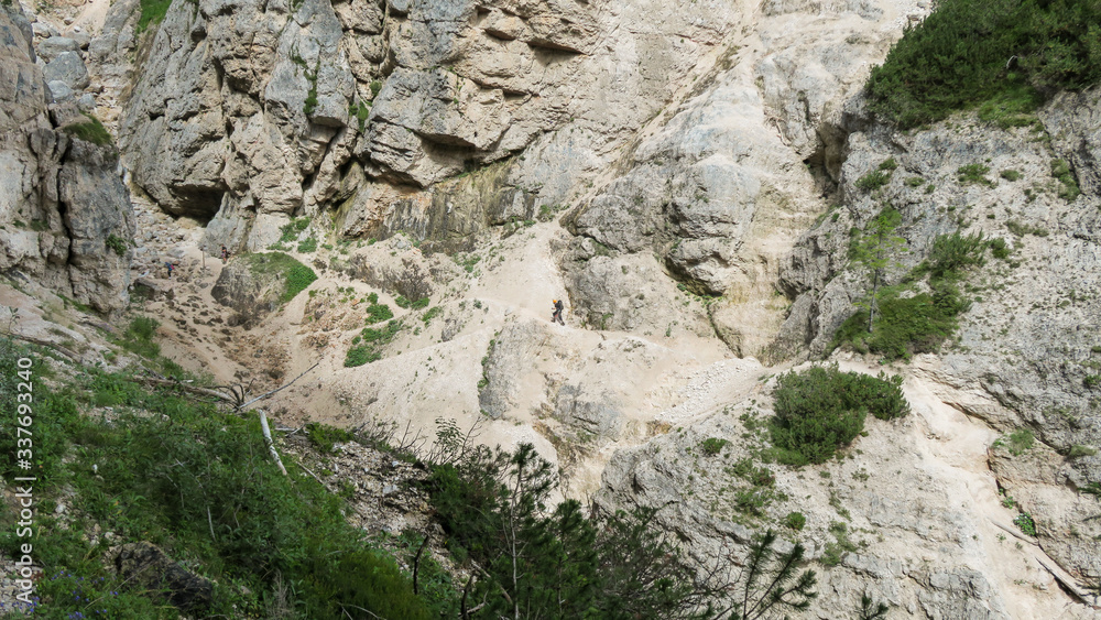 Going through a difficult trail in the full inventory located in the gorge. Dolomites in the Alps. Going through a difficult trail in the full inventory located in the gorge. Dolomites in the Alps.