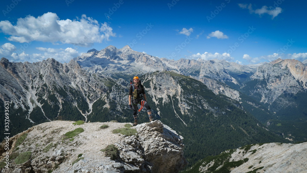 Tourist with equipment on a mountain trail in the Alps Tourist with equipment on a mountain trail in the Alps