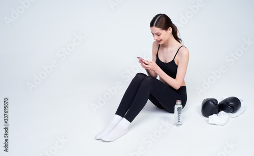 Young woman after boxing workout on a white background.