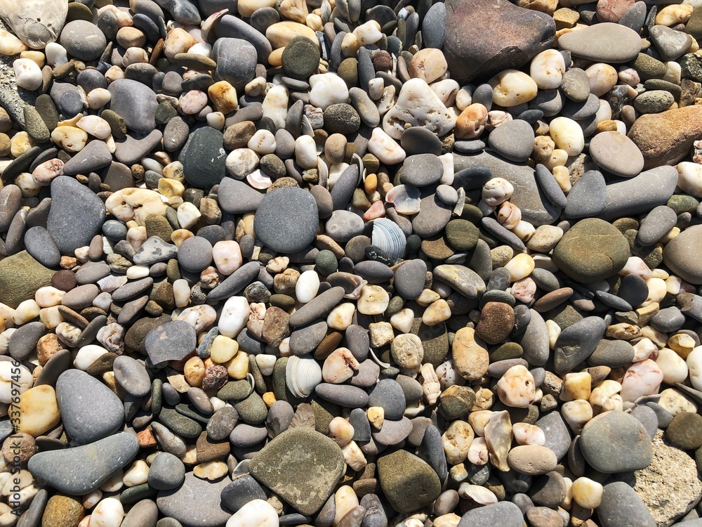 Pebbles on the beach. Abstract background with round pebbles stones Pebbles on the beach. Abstract background with round pebbles stones