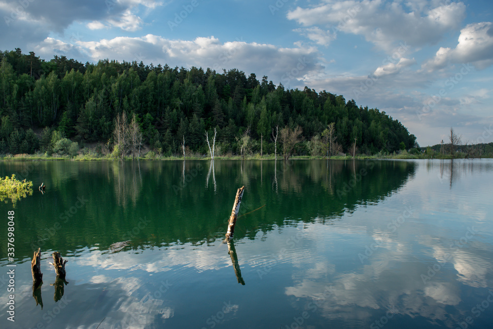 Russia, Moscow region, Dzerzhinsky - forest lake in the evening. Reflection clouds in lake.