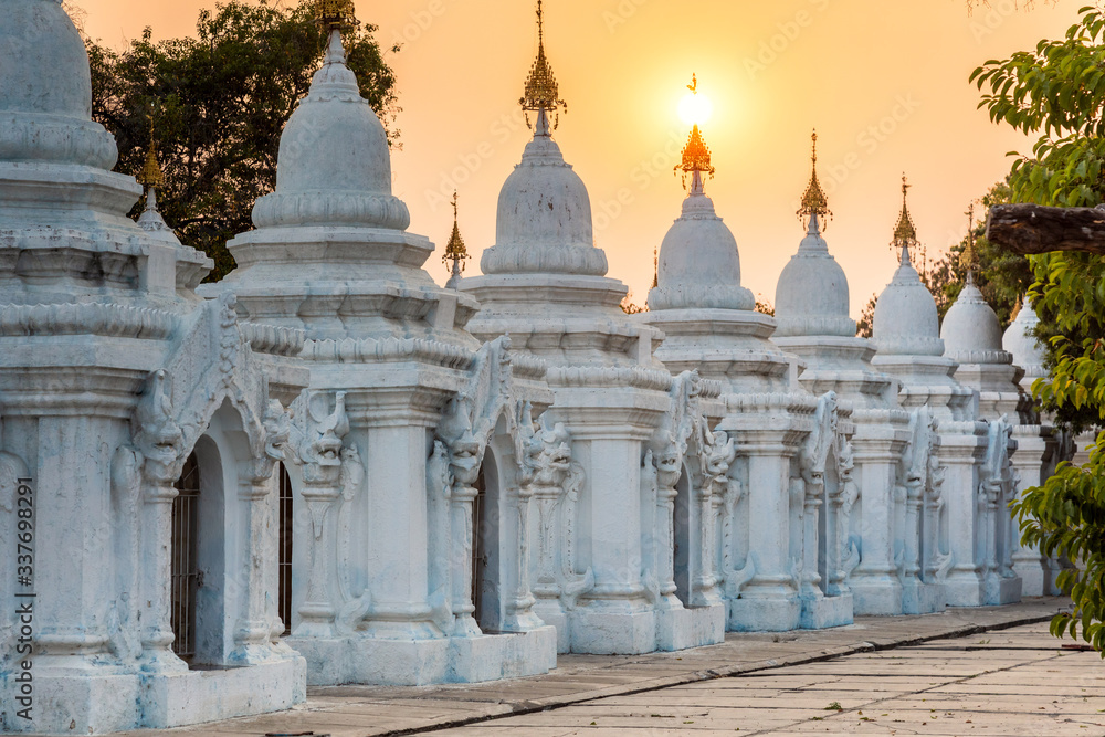 Sunset over white stupas of Kuthodaw pagoda, Mandalay, Myanmar