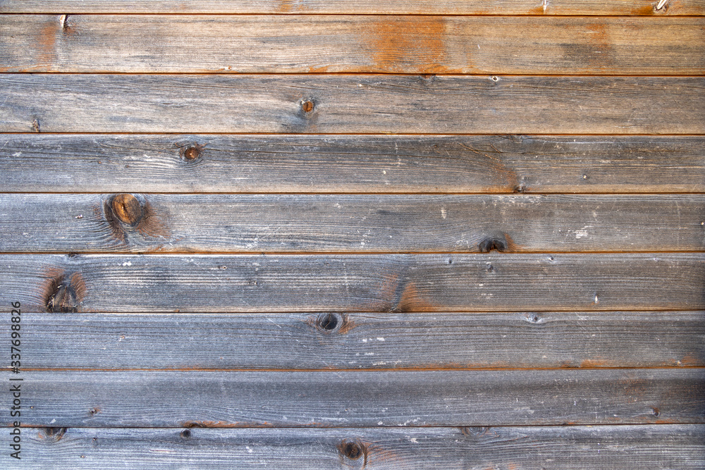 Obraz premium Close up of weathered wood planks, seasoned by age, sun and weather, for background, pattern and geometrical use. Copy space.