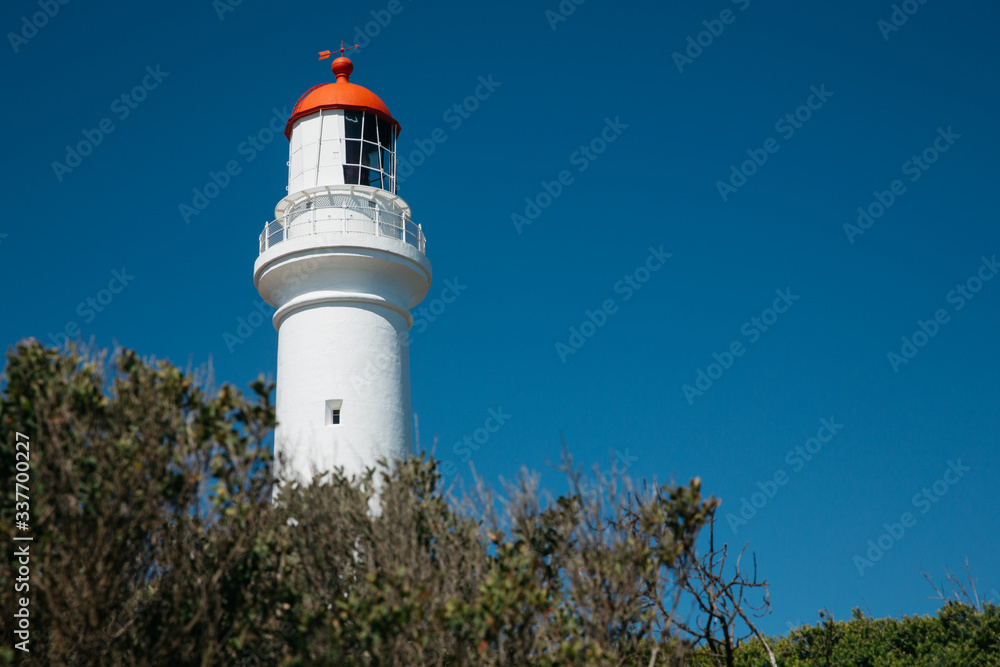 White Lighthouse in front of blue sky