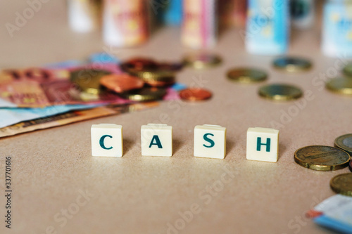 Some coins and banknotes with a word 'cash'