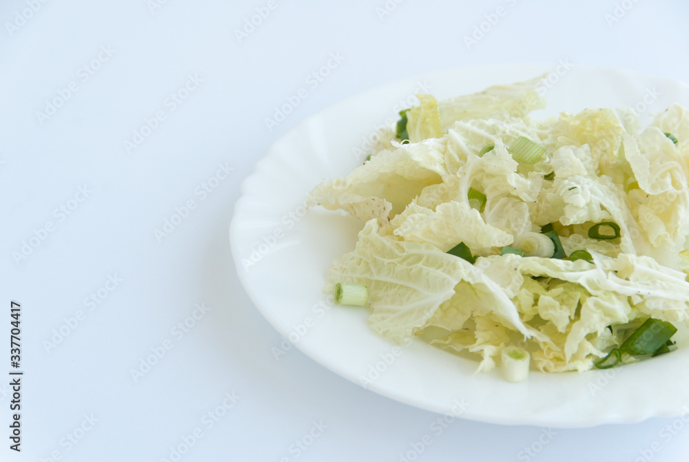 Fresh green salad on a white plate isolated on white background. Close up Fresh green salad on a white plate isolated on white background. Close up