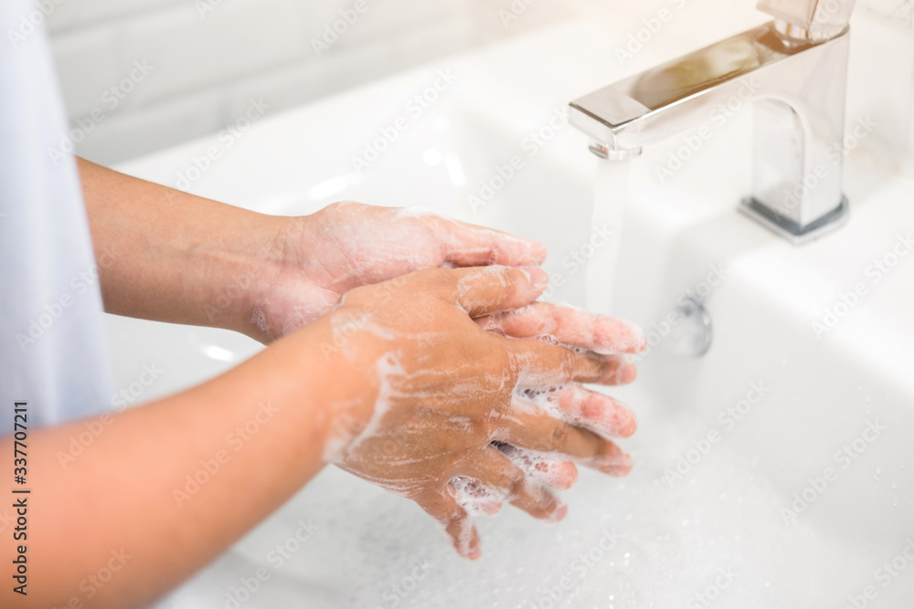 Woman Washing hands to prevent spread of CoronaVirus as well as cold, flu, bacteria at home Woman Washing hands to prevent spread of CoronaVirus as well as cold, flu, bacteria at home