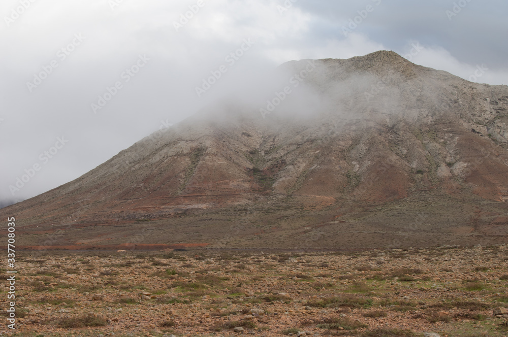 Tindaya Mountain in the fog. Tindaya Mountain Natural Monument. La Oliva. Fuerteventura. Canary Islands. Spain.