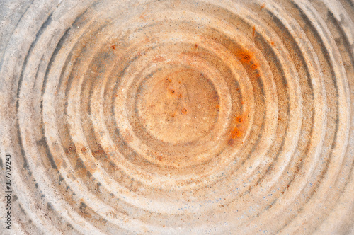 Textured grunge background of circle pattern with rust stains in a full frame close up