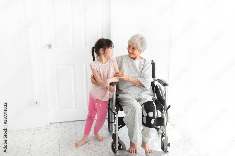 old asian female hug asian children, they feeling happy and smile, old asian people sitting on wheelchair, elderly healthcare promotion, happiness family activity old asian female hug asian children, they feeling happy and smile, old asian people sitting on wheelchair, elderly healthcare promotion, happiness family activity