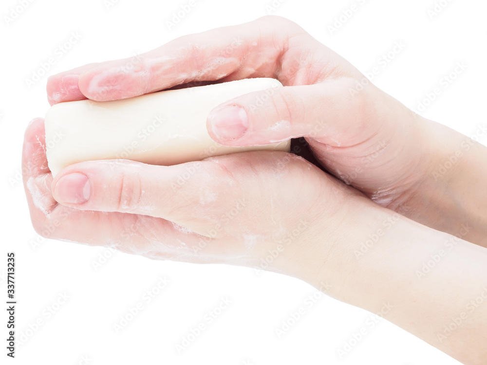 Soap hands holding a bar of soap, close-up, isolate on a white background. Antibacterial disinfectant soap as a means of protection against microbes during the coronavirus and flu pandemic Soap hands holding a bar of soap, close-up, isolate on a white background. Antibacterial disinfectant soap as a means of protection against microbes during the coronavirus and flu pandemic