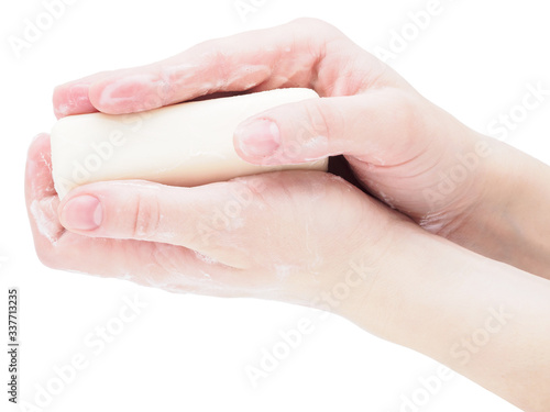 Soap hands holding a bar of soap, close-up, isolate on a white background. Antibacterial disinfectant soap as a means of protection against microbes during the coronavirus and flu pandemic