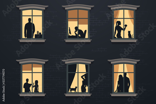 People in windows at night