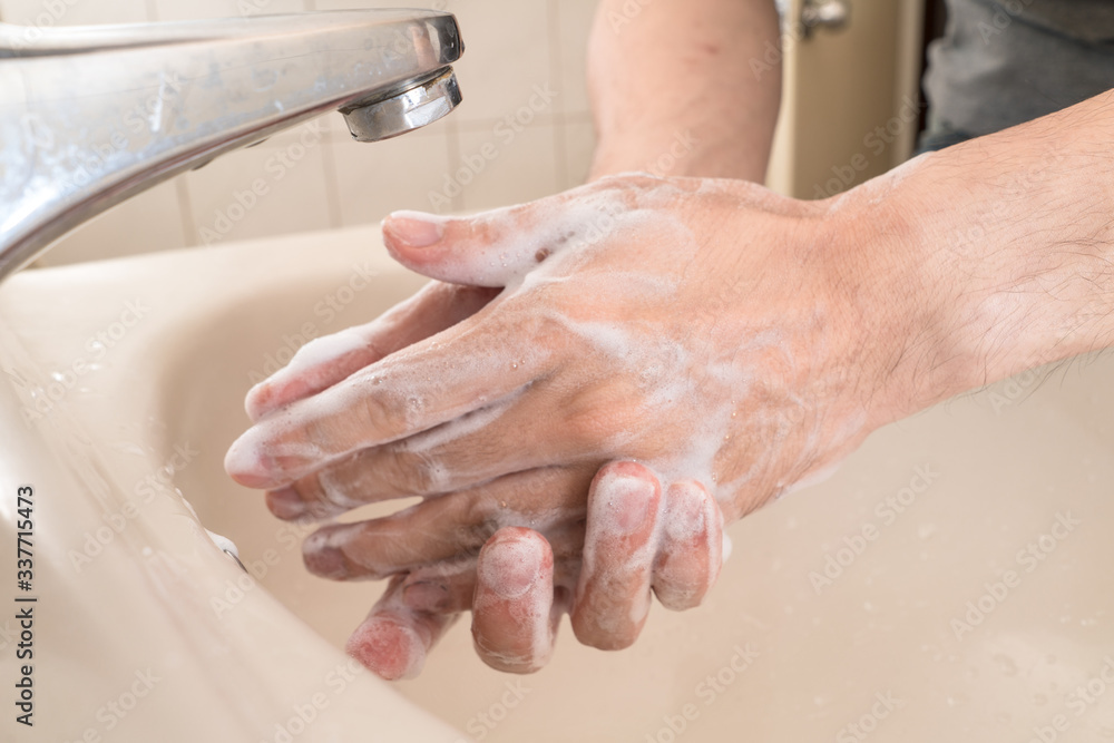 Hygiene concept. Washing hands with soap under the faucet with water Hygiene concept. Washing hands with soap under the faucet with water