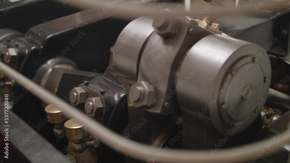 Close-up of how a huge iron crankshaft works, driving pistons of a vintage ship Close-up of how a huge iron crankshaft works, driving pistons of a vintage ship