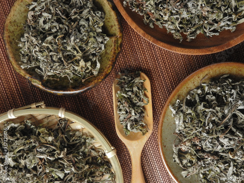 Top view of dry mugwort on bamboo mat. Be used to ward off evil spirits and to drive away mosquitoes during the Dragon Boat Festival in Taiwan.  Chinese herbal medicine. With copy space.