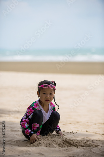 Girls playing in the sand at the beach