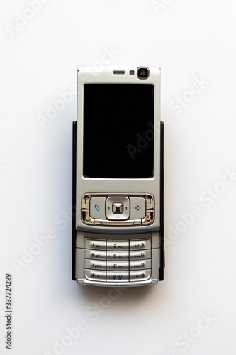 Old cell phone on the white background