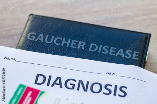 Diagnosis and Book about Gaucher Disease and medication, thermometer and pills. Medic concept