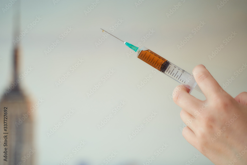 a syringe with a medicine in a hand a syringe with a medicine in a hand