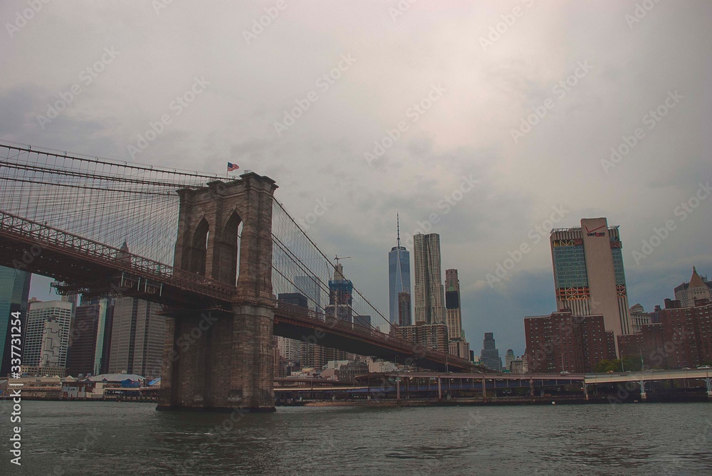 A cloudy day over the Brooklyn Bridge looking towards Manhattan in New York.