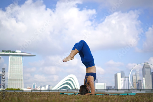 Asian Chinese Female Yogi outdoor yoga exercise under the sun
