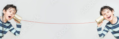 Little boy holding a can with a cord