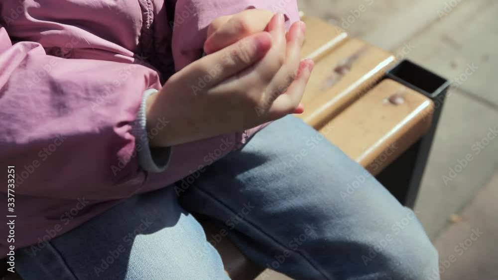 the child rubs an antiseptic sprayed from above into his hands, close-up, Full HD, no sound