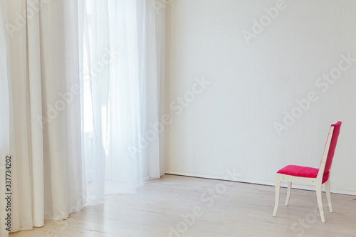 one red chair in the interior of an empty white office