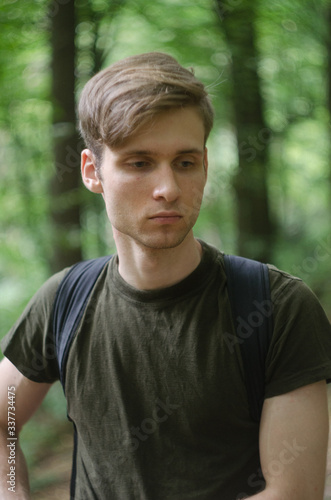 portrait of young man in the forest © slavo.slavo