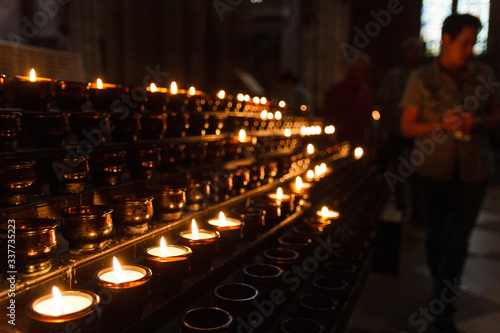 Freiburg im Breisgau, Baden-Wuerttemberg, Germany. Burning candles as an offering in the city's cathedral photo