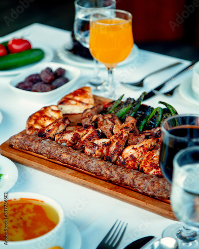 lule and chicken kebab with vegetables on the table