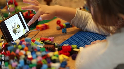 Little girl online learning and creating at home. Quarantine and Social distancing concept.