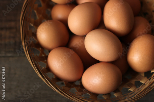 Eggs in a basket on a wooden background