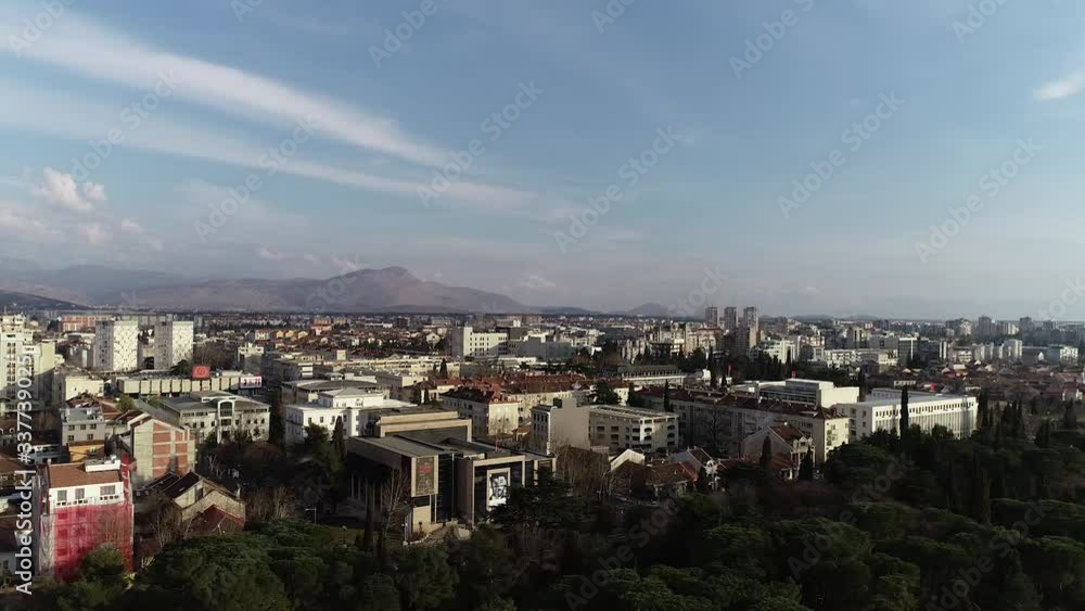 Aerial shot of Podgorica city with a Moraca river. Sunny and bright day with a blue sky. Aerial shot of Podgorica city with a Moraca river. Sunny and bright day with a blue sky.