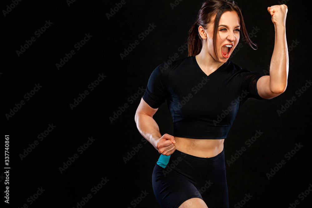 Sprinter and runner girl. Running concept. Woman running on the black background. The concept of a healthy lifestyle and sport. Woman in sportswear. Sprinter and runner girl. Running concept. Woman running on the black background. The concept of a healthy lifestyle and sport. Woman in sportswear.