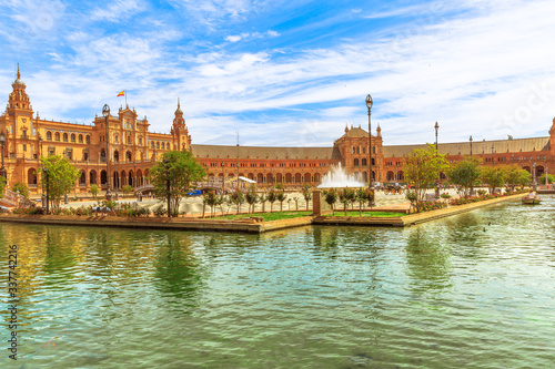 Panorama of Spain Square in Andalusia, Spain reflects on canal of Guadalquivir river in Seville.