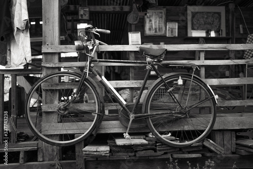 Old bike kept away from the ground with black and white images.