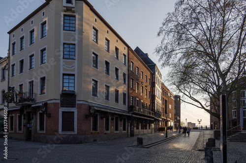 Empty street with closing shop, cafe and restaurant during quarantine from contagion of COVID-19 on walking street and plaza in old town in Düsseldorf, Germany.