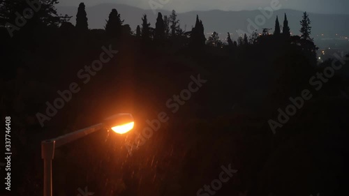 Thunderstorm lightning and torrential rain in the road lighting lantern. Faro Portugal.
