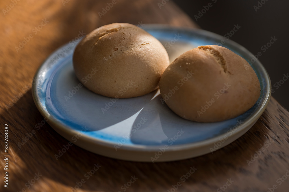 Two Artisanal Mini Cakes on a Rustic Blue Plate - Macro Closeup on Wooden Table Two Artisanal Mini Cakes on a Rustic Blue Plate - Macro Closeup on Wooden Table