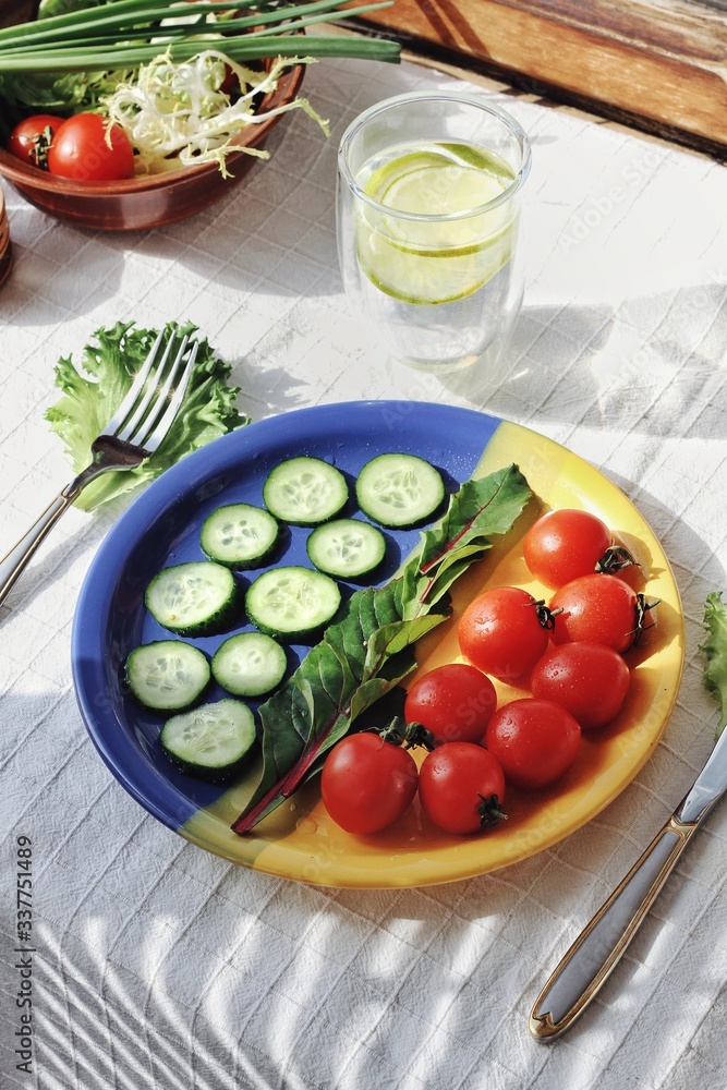 Dietary food background: vegetable salad with cherry tomatoes and cucumbers, vegan cuisine