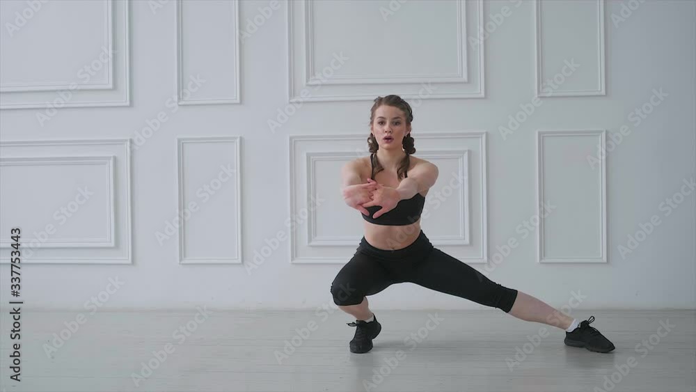 The girl fitness instructor demonstrates lunge exercise to stretch the muscles. The girl fitness instructor demonstrates lunge exercise to stretch the muscles.
