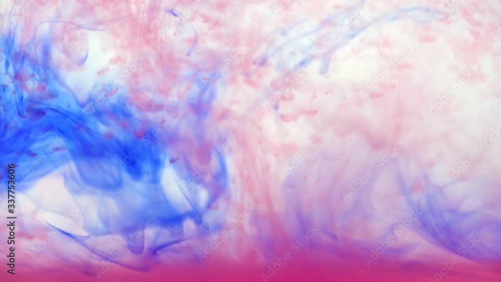 Blue and pink ink mixing slowly in water aquarium, abstract background Blue and pink ink mixing slowly in water aquarium, abstract background